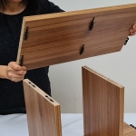An individual preparing to connect two pieces of wood using the FIYU® connectors, showcasing the initial stage of assembly and the ease of alignment with this revolutionary tool.